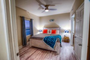 a bedroom with a bed with orange pillows at Laketown Wharf Resort 1036 By Aneliya in Panama City Beach +79 photos