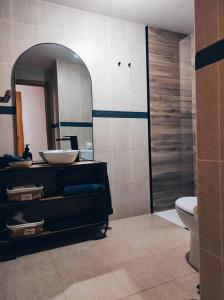 a bathroom with a sink and a mirror at O'Eirado Playa de Quenxe in Corcubión +14 photos