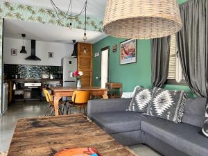 a living room with a couch and a table at Ca n'Alorda Holiday Home Cala Llombards piscina, wifi, seguridad y relax in Santanyi