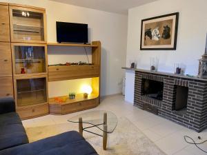 a living room with a couch and a fireplace at Ferienwohnung Harzblick in Bad Grund