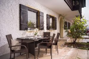 a black table and chairs on a patio at Ferienwohnung 5 Bergschlössl Oberaudorf in Oberaudorf