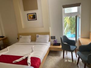 Postel nebo postele na pokoji v ubytování Hotel Sangeeth Palace