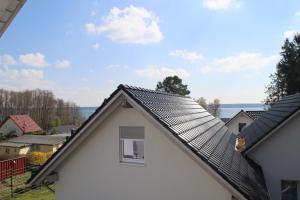 a roof of a white house with a window at Auszeit am See in Plau am See