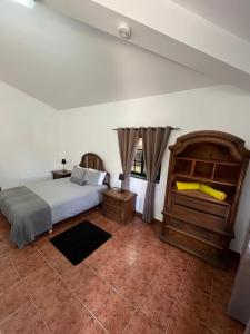 
a bedroom with a bed and a desk at Silver Coast Vacation Inn in Lourinhã
