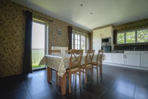 a dining room with a table and chairs in a kitchen at land s' end in Philippine