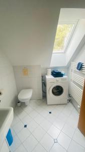 a bathroom with a washing machine and a toilet at Schlossapartments Wolfsberg in Wolfsberg +15 photos
