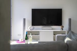 a living room with a couch and a flat screen tv at NEU MoselTOP Penthouse - traumhaft in Traben-Trarbach