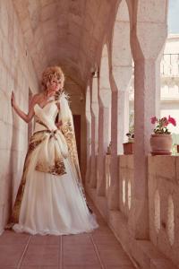 a woman in a wedding dress standing in a hallway at Nature Park Cave Hotel in Göreme