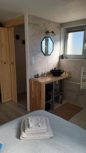 a bathroom with a sink and a bed in a room at Harmony in Publier