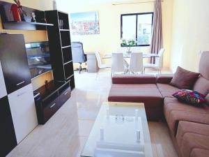 a living room with a couch and a table at Ryaproperty in Morro del Jable