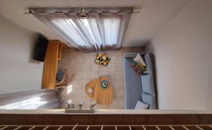 una pequeña cocina con fregadero y ventana en Maistros Suites - Péra en Skopelos Town