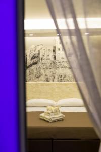 a view of a bed through a window at Rooms Dream Tropea in Tropea