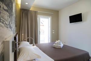 a hospital room with a bed and a television at Rooms Dream Tropea in Tropea