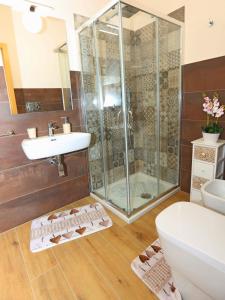 a bathroom with a shower and a toilet and a sink at Casa vacanze - "O Tunnu" in Avola +30 photos