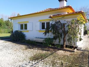 a white house with a tree in front of it at R3 Service - Cozy Old House in Borralha