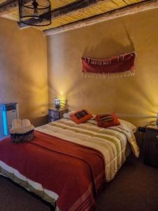 a bedroom with a bed with two towels on it at Hotel boutique Pukarainca in Uspallata