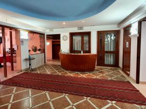 a large lobby with a tub in the middle of a room at HOTEL PERLA in Massa Lombarda