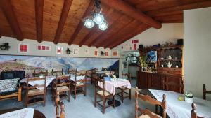 a dining room with tables and a painting on the wall at BnB "A la Crus" in Crana