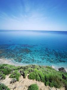 a view of the ocean from the top of a hill at Giannis Stella apartment in Mourteri