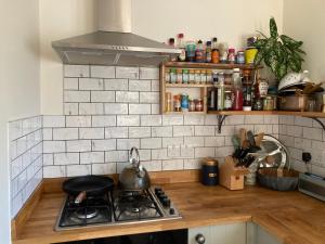 a kitchen with a stove with a tea kettle on it at Highfields lodge in Dymchurch