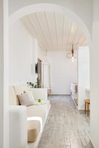 a white living room with a white couch at Agnadi studios in Maltezana