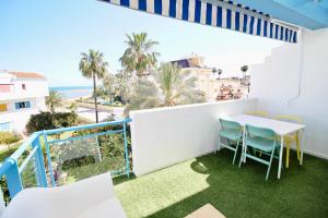 a balcony with a table and chairs and the ocean at La Alberca 16 in Denia