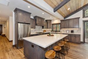 a kitchen with wooden cabinets and a large island with stools at 001 - Living the Dream in Big Bear Lake