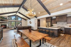 an open kitchen and living room with a wooden ceiling at 001 - Living the Dream in Big Bear Lake