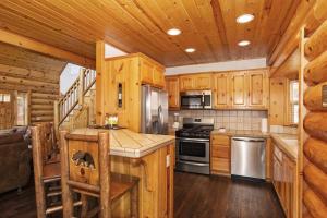 a kitchen with wooden cabinets and stainless steel appliances at 004 - Bearadise in Big Bear Lake