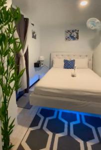a bedroom with a bed with a blue rug at Blue Royalty in Portmore