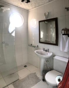 a bathroom with a sink and a toilet and a shower at Pouso do Chico Rey in Ouro Preto