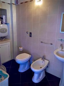 a bathroom with a toilet and a sink at Lovely Cottage in Castellammare del Golfo