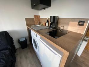 a small kitchen with a sink and a counter top at Studio 20m2 Avec Terrasse 16m2 Vue sur la Vallée in Habère-Poche