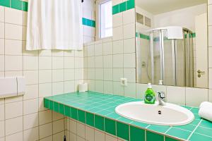 y baño con lavabo y espejo. en Fränkische Landherberge, Hotel Garni, en Seßlach