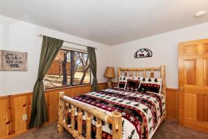 a bedroom with a wooden bed and a window at 018 - Bearly Home in Big Bear Lake