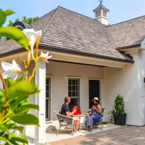 two women sitting on the porch of a house at Old Ivy Walk in Niagara-on-the-Lake