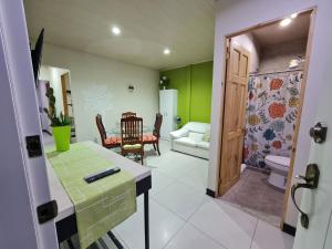 a room with a bathroom with a toilet and a table at Fully-equipped 2-bedroom apartment in San José in San José