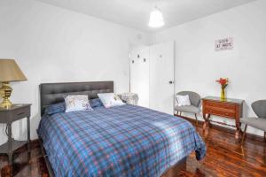 a bedroom with a bed and a table and a chair at Cozy house to call home away from home in Maryland Heights