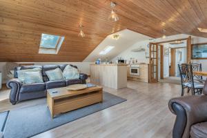 a living room with a couch and a table at Sail Loft in Yarmouth