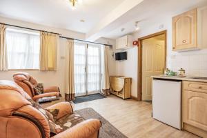 Una sala de estar con dos sofás y una cocina. en Sail Loft Annexe, en Yarmouth