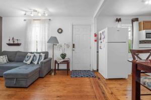 a living room with a couch and a refrigerator at Cozy house to call home away from home in Maryland Heights +11 photos