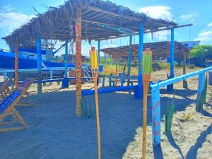 a playground on the beach with a wooden structure at Hospedaje Algarrobo Machalilla in Machalilla