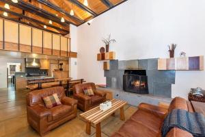 a living room with leather furniture and a fireplace at 061 - Boulder Bay Retreat in Big Bear Lake