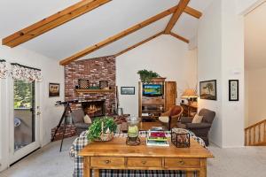 a living room with a table and a fireplace at 079 - Golf and Ski in Big Bear Lake