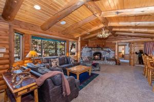 a living room with a couch and a fireplace at 015 - Hidden Bridge Cabin in Big Bear Lake