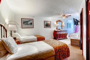 a hotel room with two beds and a television at Vail Run Resort in Vail