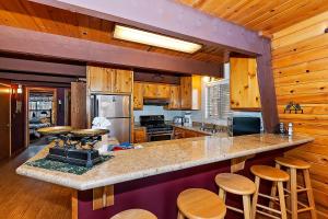 a kitchen with a counter and some wooden walls at 070 - Tree Top Villa in Big Bear Lake
