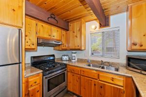 a kitchen with wooden cabinets and a stove top oven at 070 - Tree Top Villa in Big Bear Lake
