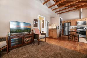 a living room with a large flat screen tv at 060 - The Angeles Chalet in Big Bear City