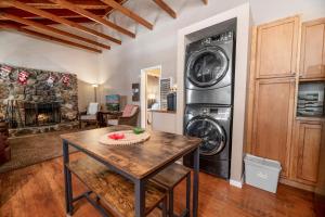 a laundry room with a washer and dryer and a table at 060 - The Angeles Chalet in Big Bear City